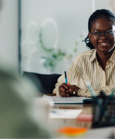 smiling-black-woman-attending-a-business-meeting-i-2025-01-15-17-22-46-utc_Medium